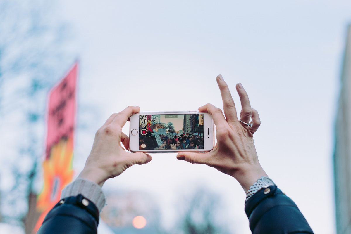 person taking photo using iPhone 6 during daytime
